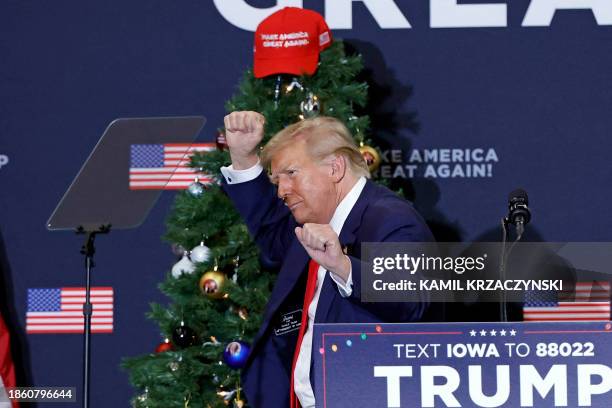 Former US President and 2024 presidential hopeful Donald Trump gestures during a campaign event in Waterloo, Iowa, on December 19, 2023. An appeals...