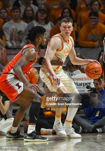 Tennessee Volunteers guard Dalton Knecht controls the ball against Illinois Fighting Illini forward Quincy Guerrier during the college basketball...