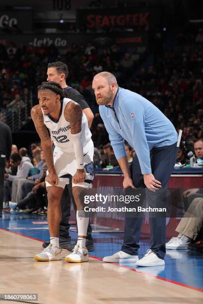 Ja Morant of the Memphis Grizzlies and Head Coach Taylor Jenkins of the Memphis Grizzlies look on during the gameagainst the New Orleans Pelicans on...