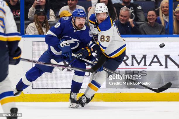 Nicholas Paul of the Tampa Bay Lightning against Jake Neighbours of the St Louis Blues during the second period at Amalie Arena on December 19, 2023...