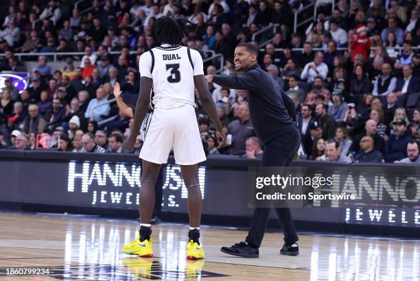 Providence Friars head coach Kim English speaks with Providence Friars guard Garwey Dual during the college basketball game between Marquette Golden...