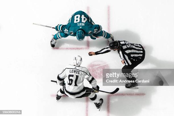 An overhead view of Tomas Hertl of the San Jose Sharks and Trevor Lewis of the Los Angeles Kings facing off at SAP Center on December 19, 2023 in San...