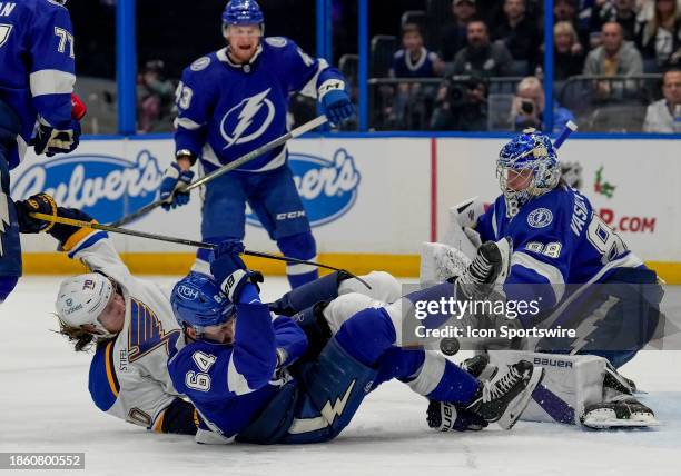 St. Louis Blues center Oskar Sundqvist attempts to shoot as Tampa Bay Lightning center Tyler Motte blocks the shot during the NHL Hockey match...