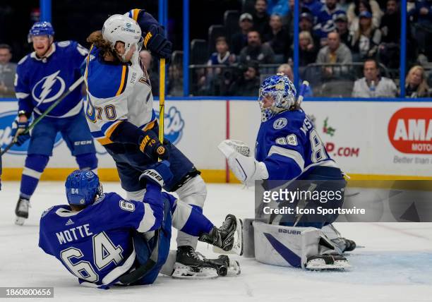 St. Louis Blues center Oskar Sundqvist attempts to shoot as Tampa Bay Lightning center Tyler Motte blocks the shot during the NHL Hockey match...