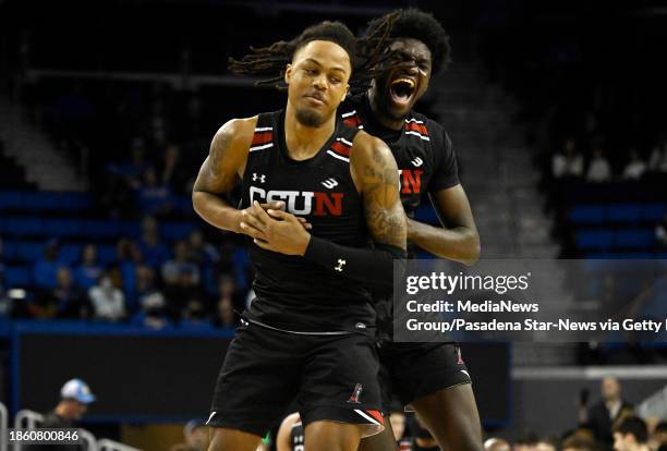 Los Angeles, CA Dionte Bostick, left, celebrates with teammate Bryan Ndjonga of the Cal State Northridge Matadors after defeating the UCLA Bruins...