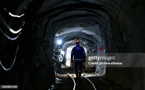Dpatop - PRODUCTION - 12 December 2023, Saxony, Bad Schlema: Foreman Jörg Neubert walks underground through a restored roadway on the Markus-Semmler...