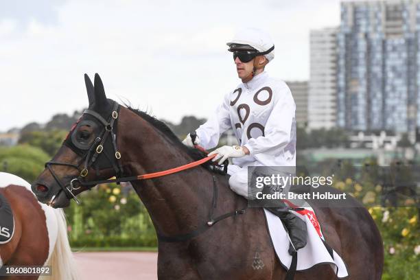 Jordan Childs returns to the mounting yard on Katsu after winning the Resimax Group Kensington Stakes at Flemington Racecourse on December 20, 2023...