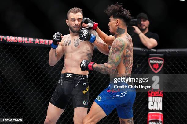 Andre Fili punches Lucas Almeida of Brazil in a featherweight fight during the UFC 296 event at T-Mobile Arena on December 16, 2023 in Las Vegas,...