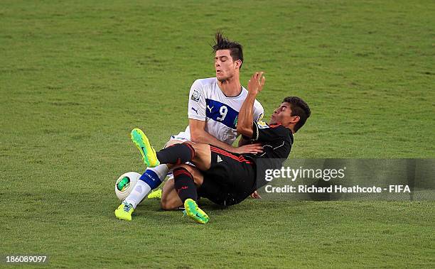 Alberto Cerri of Italy is tackled by Salomon Wbias of Mexico during the FIFA U-17 World Cup UAE 2013 Round of 16 match between Italy and Mexico at...