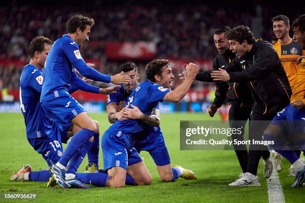 Jaime Mata of Getafe CF celebrates after scoring their side's second goal with his teammates during the LaLiga EA Sports match between Sevilla FC and...