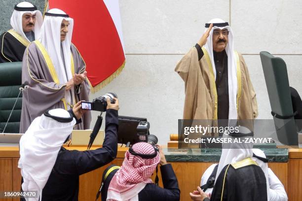 Kuwait's new emir Sheikh Meshal al-Ahmad al-Sabah salutes as he swears in before lawmakers as the country's 17th ruler, at the Kuwaiti parliament, on...