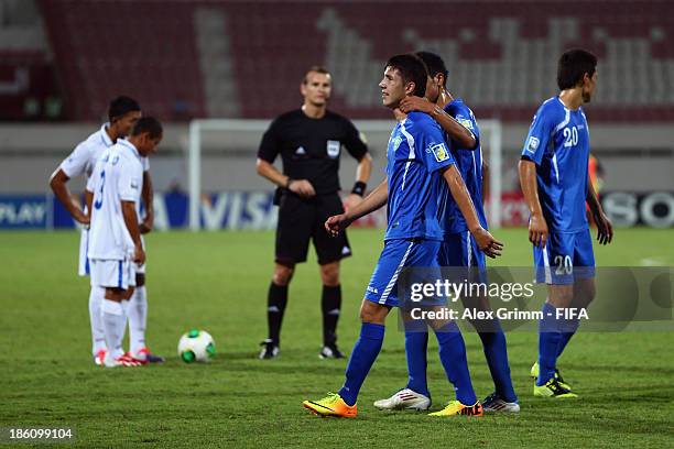 Akramjon Komilov of Uzbekistan leaves the pitch after being sent off by referee Pavel Kralovec during the FIFA U-17 World Cup UAE 2013 Round of 16...