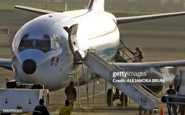 Zarai Toledo boards the airplane to ciudad de Piura where she lives with her mother Lucrecia Orozco, at the airport in Lima, 18 October 2002....