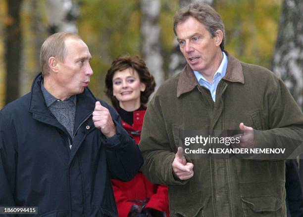 British Prime Minister Tony Blair and Russian President Vladimir Putin discuss as they walk in the residence of Zavidovo , in the Tver region, some...