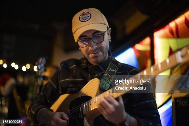 Delil Cengiz, electric guitarist of De Lejos Music band performs on a stage during flamenco show, the authentic Spanish dance, in Ankara, Turkiye on...