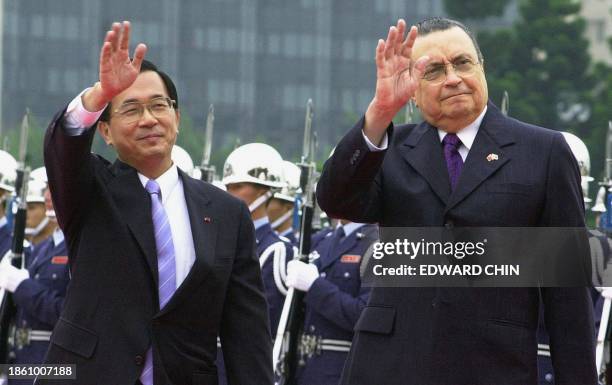 Costa Rican President Abel Pacheco and Taiwan President Chen Shui-bian wave to wellwishers after a 21-gun salute ceremony welcoming Pacheco at Chiang...