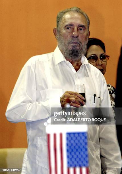 Cuban President Fidel Castro, drinks wine 30 September 2002, at the Pabexpo fair in La Habana, at the end of its fifth day of exhibition of US...