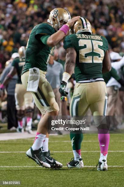 Bryce Petty of the Baylor Bears celebrates with teammate Lache Seastrunk after a Bears touchdown against the Iowa State Cyclones on October 19, 2013...