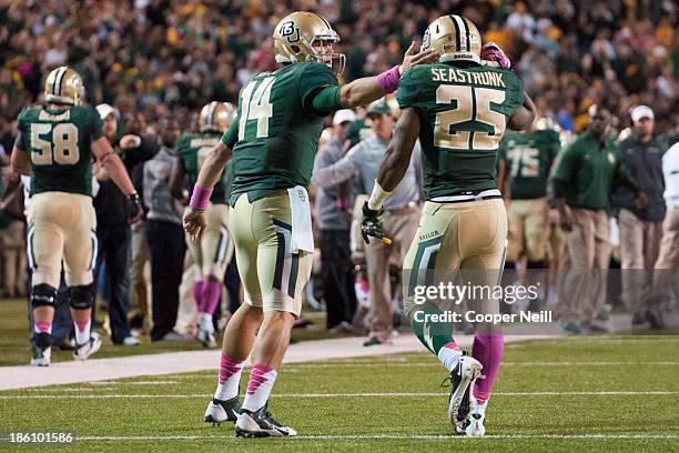 Bryce Petty of the Baylor Bears celebrates with teammate Lache Seastrunk after a Bears touchdown against the Iowa State Cyclones on October 19, 2013...