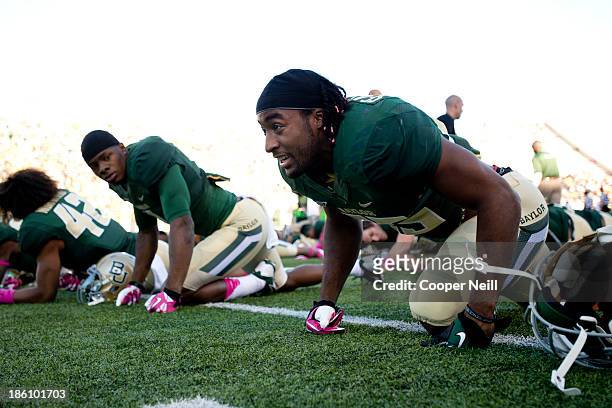 Lache Seastrunk of the Baylor Bears stretches before kickoff against the Iowa State Cyclones on October 19, 2013 at Floyd Casey Stadium in Waco,...