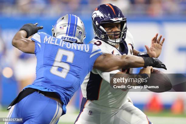 Ifeatu Melifonwu of the Detroit Lions forces a fumble by Russell Wilson of the Denver Broncos during the first quarter at Ford Field on December 16,...