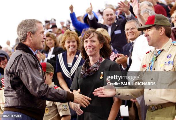 President George W. Bush greets a Girl Scout leader and a Boy Scout Leader during a campaign rally 27 September 2002 at the Coconino County...