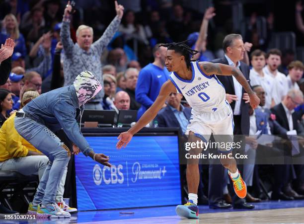 Rob Dillingham of the Kentucky Wildcats reacts after hitting a three-point basket against the North Carolina Tar Heels during the second half of the...