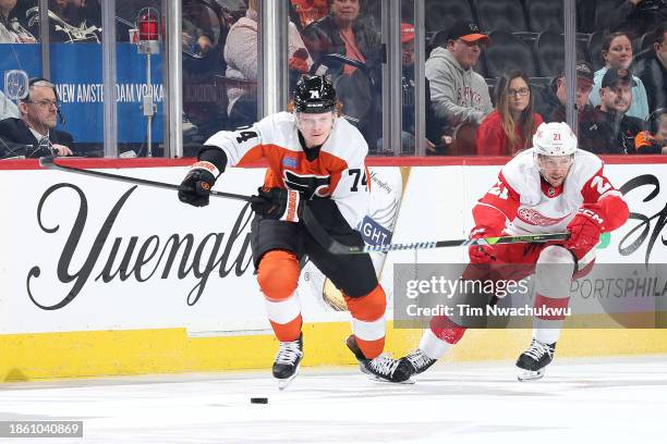 Owen Tippett of the Philadelphia Flyers and Austin Czarnik of the Detroit Red Wings challenge for the puck during the first period at the Wells Fargo...