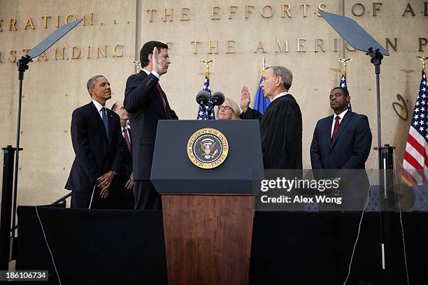 Director James Comey participates in a ceremonial swearing-in, officiated by Judge John Walker , as his wife Patrice , U.S. President Barack Obama ,...