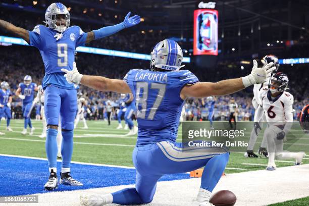 Sam LaPorta of the Detroit Lions celebrates his touchdown with Jameson Williams during the second quarter against the Denver Broncos at Ford Field on...