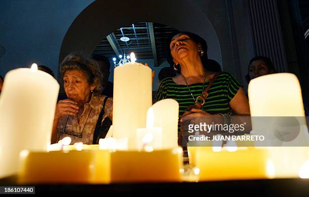 Sofia Miselem People pray and light candles before the tomb of doctor Jose Gregorio Hernandez, during a mass at the Holy Church of La Candelaria, in...