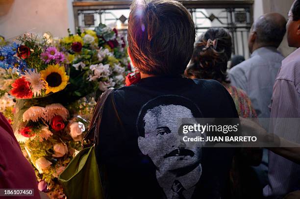 Sofia Miselem A woman wearing a T-shirt with an image of late doctor Jose Gregorio Hernandez, participates in a mass at the Holy Church of La...