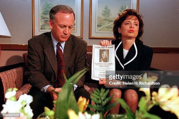 Patsy Ramsey holds up a reward sign for any information leading to the arrest of their daughter JonBenet Ramsey in Boulder, Colorado on May 1, 1997....