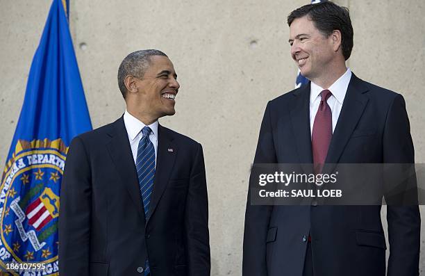President Barack Obama speaks with new FBI Director James Comey during an installation ceremony at Federal Bureau of Investigation Headquarters in...
