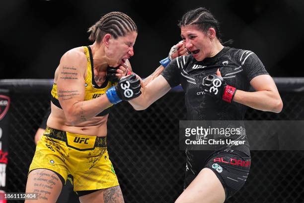 Irene Aldana of Mexico punches Karol Rosa of Brazil in a bantamweight fight during the UFC 296 event at T-Mobile Arena on December 16, 2023 in Las...