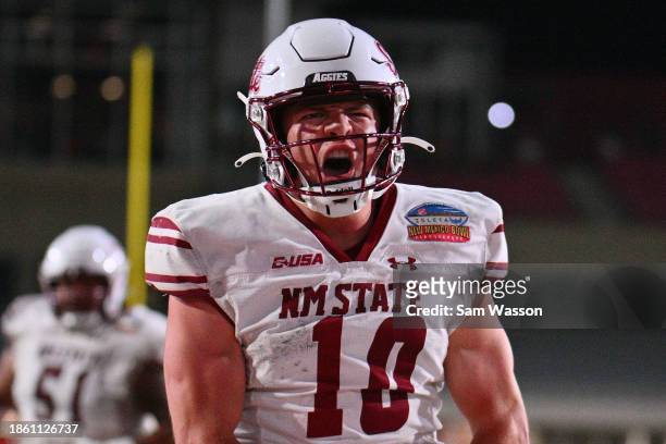 Quarterback Diego Pavia of the New Mexico State Aggies celebrates after scoring a touchdown against the Fresno State Bulldogs during the second half...