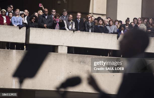 Employees listen as US President Barack Obama speaks during an installation ceremony for new FBI Director James Comey at Federal Bureau of...