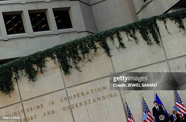 President Barack Obama listens as new Federal Bureau of Investigation director James Comey speaks during his installation ceremony at the FBI...