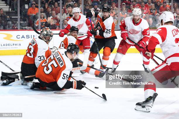Samuel Ersson and Rasmus Ristolainen of the Philadelphia Flyers block a shot during the third period against the Detroit Red Wings at the Wells Fargo...