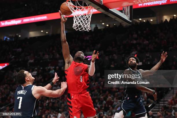 Jerami Grant of the Portland Trail Blazers drives to the basket as Dwight Powell of the Dallas Mavericks defends during the second quarter at Moda...