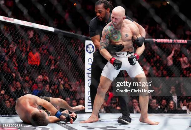 Josh Emmett reacts to his knock out of Bryce Mitchell in a featherweight fight during the UFC 296 event at T-Mobile Arena on December 16, 2023 in Las...