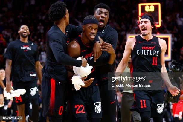 Jimmy Butler of the Miami Heat celebrates with teammates after hitting a buzzer beater against the Chicago Bulls at Kaseya Center on December 16,...