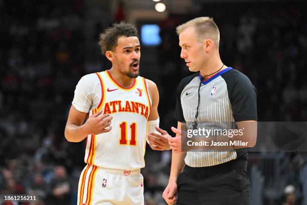 Trae Young of the Atlanta Hawks argues a call with referee Tyler Ricks during the fourth quarter against the Cleveland Cavaliers at Rocket Mortgage...