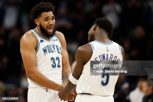 Anthony Edwards of the Minnesota Timberwolves celebrates his basket against the Indiana Pacers with teammate Karl-Anthony Towns in the fourth quarter...