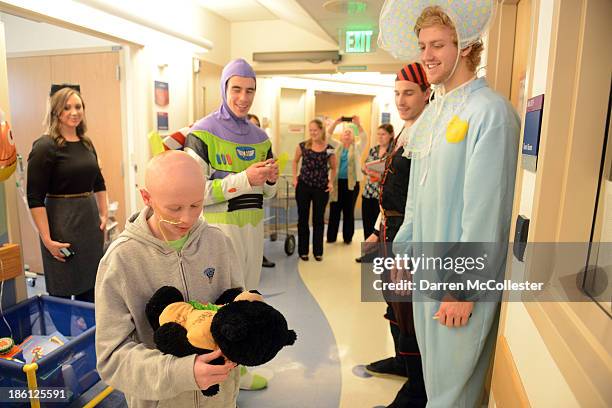 Reilly Smith, Matt Bartkowski, and Dougie Hamilton of the Boston Bruins celebrate Halloween with Owen at Boston Children's Hospital on October 28,...