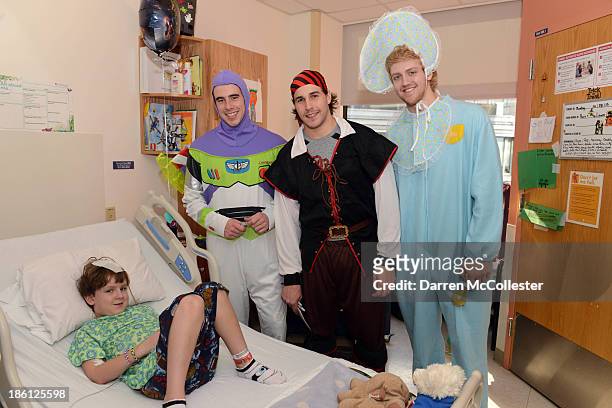 Reilly Smith, Matt Bartkowski, and Dougie Hamilton of the Boston Bruins celebrate Halloween with Brendan at Boston Children's Hospital on October 28,...