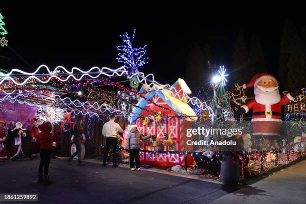 People visit De Sario family house decorated for Christmas in Toronto, Canada on December 19, 2023. De Sario family house turned into a Festival of...