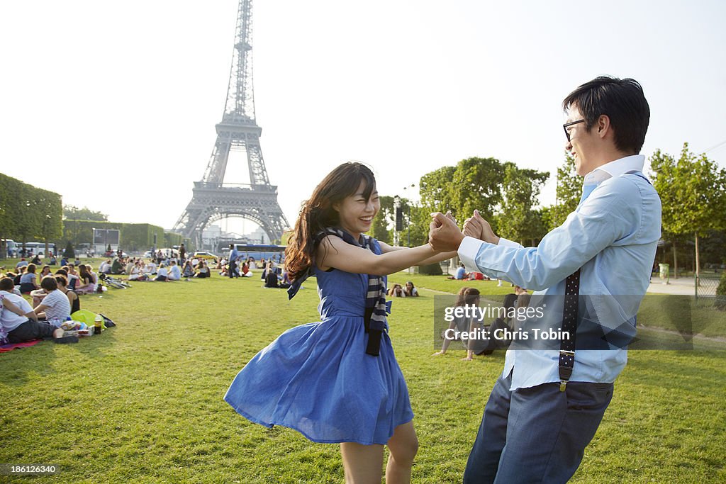 Young couple dancing at the Eiffel Tower