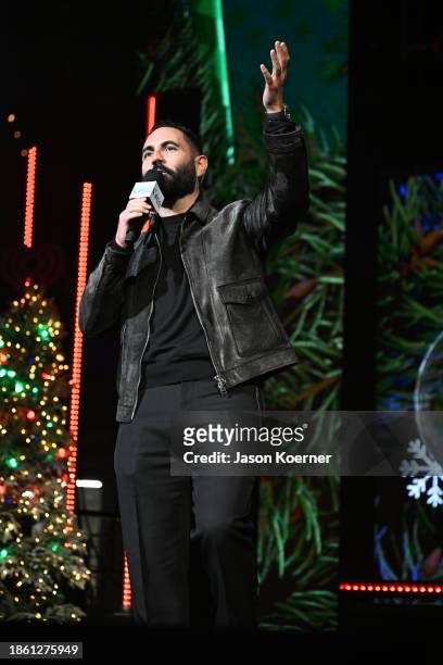 Enrique Santos speaks onstage during iHeartRadio Y100's Jingle Ball 2023 at Amerant Bank Arena on December 16, 2023 in Miami, Florida.