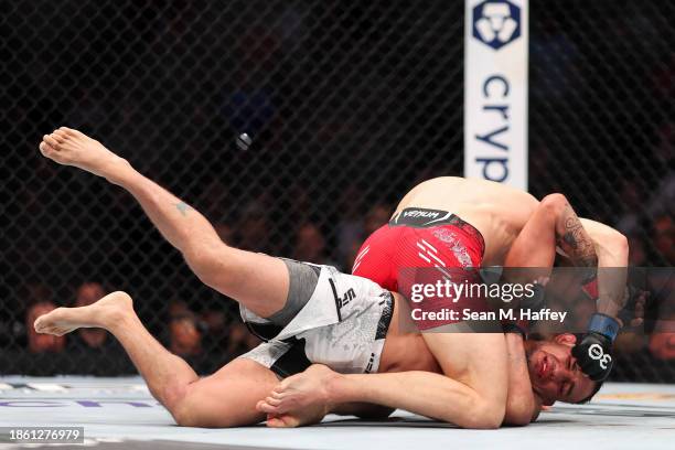 Paddy Pimblett of England wrestles Tony Ferguson of the United States in a lightweight fight during the UFC 296: Edwards vs. Covington event at...